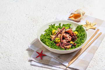 Octopus salad with lettuce, olives and spices in a bowl. Fresh and healthy seafood, marine decor