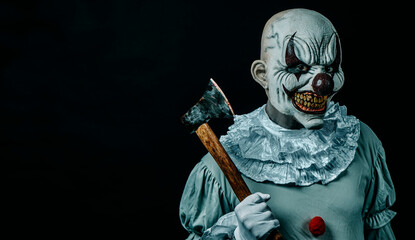 creepy evil clown with an axe
