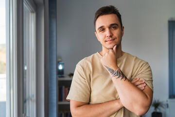 A portrait of a man standing in his home office