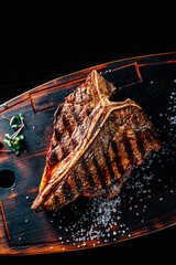 Grilled T-bone Steak on bones on wooden board