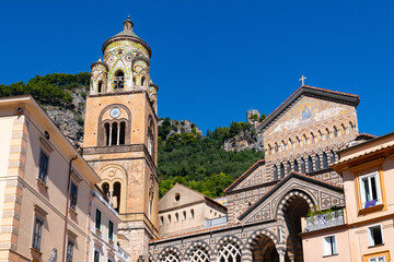 Fototapeta na wymiar Amalfi Cathedral “Duomo di Amalfi Cattedrale di Sant'Andrea“ is a medieval Roman Catholic cathedral in the Piazza del Duomo, Amalfi, Italy. Coloruful facades and bell tower in world heritage village.