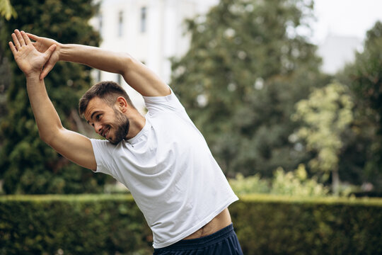 Man stretching in the park before run
