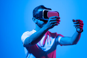 Young bearded man using virtual reality headset. VR, future, gadgets, technology, education online, studying, video game concept, metaverse.