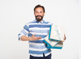 Happy beard Man in striped shirt hand pointing to present boxes in other hand. Smiling cheerful man holding three gift white-blue boxes in hands isolated on white background