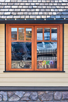 Street cafe window with colour light sign Open inside