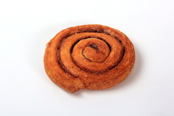 Delicious cinnamon bun on a white background. Round cinnamon bun