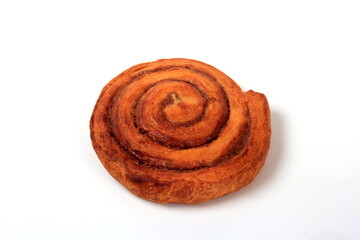 Delicious cinnamon bun on a white background. Round cinnamon bun