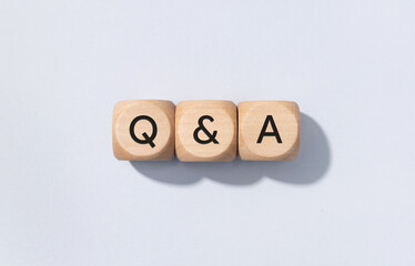 Q&A or questions and answers concept. Text on Wooden cube blocks isolated on gray background