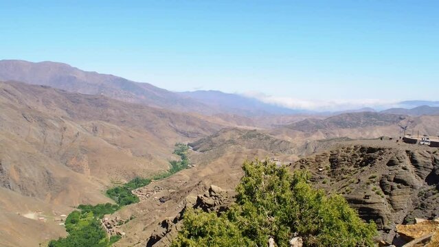 4K Footage of panorama view to Atlas mountain with goats walking, Morocco, North Africa