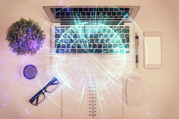 Business theme hologram drawings over computer on the desktop background. Top view. Multi exposure....