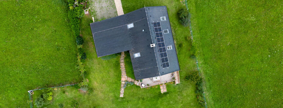 Top view of solar photovoltaic panels on roof, alternative energy, saving resources and sustainable lifestyle concept.