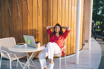 Resting student with laptop and coffee on terrace