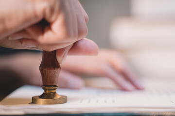 A seal to show approval of an agreement or contract by an authorized person. A businesswoman is...
