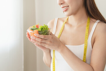 Happy young woman holding bowl of vegan meal for wellness health.