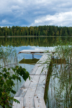 Wooden footbridge in lake Katvari in September on a cloudy day in Latvia