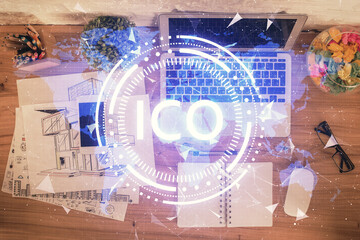 Blockchain theme hologram drawings over computer on the desktop background. Top view. Double...