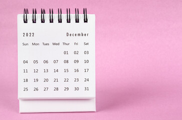Obraz na płótnie Canvas The December 2022 desk calendar on pink color background.