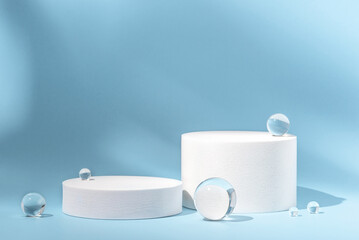 White podium with glass balls on a blue background for product presentation. Minimal concept and...