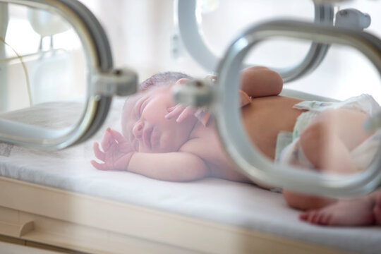 A newborn baby lies in boxes in the hospital. A child in an incubator. Neonatal and Premature Intensive Care Unit