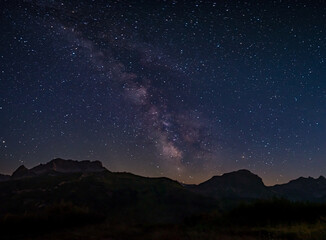 Naklejka na ściany i meble Breathtaking starry sky with milky way in austrian mountains