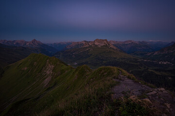Naklejka na ściany i meble Stunning sunset hike from the top in the austria mountain