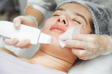 Ultrasonic cosmetic scrubber. Facial cavitation procedure. Salon skin care procedure. Professional...