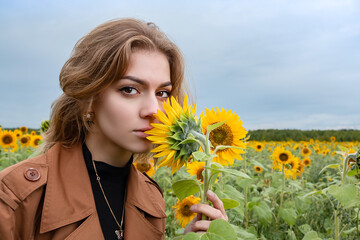 Girl in a field of blooming sunflowers.