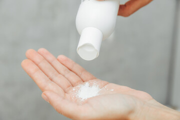 Cosmetologist pour the powder into the palm of your hand. skin care. powder for hair removal.