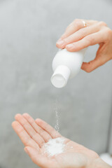 Cosmetologist pour the powder into the palm of your hand. skin care. powder for hair removal.