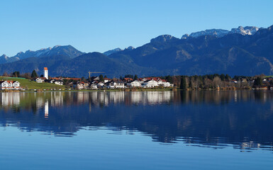 scenic and serene lake Hopfensee in Schwangau with the Bavarian Alps in the background on a sunny November day (Allgaeu, Bavaria, Germany)