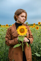 Girl in a field of blooming sunflowers.