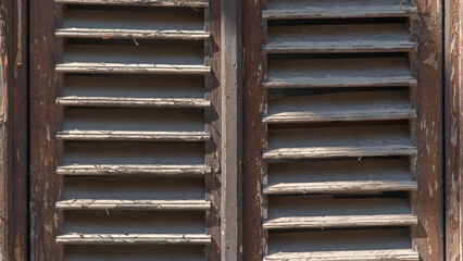 Old dilapidated wooden shutters it in the form of a lattice