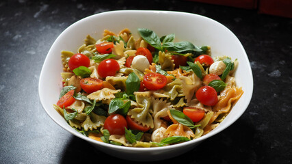 Salad with tomato, mozzarella, basil, and farfalle pasta