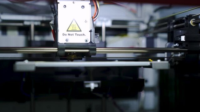 Head of FDM 3d printer prints the plastic model. Additive technology. Close up