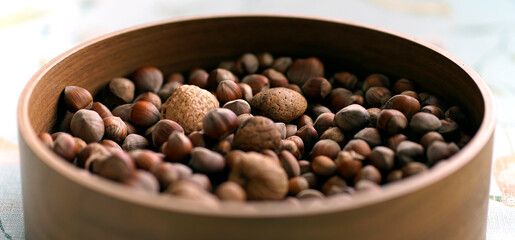 Obraz premium Bowl with nuts: almonds, walnuts and hazelnuts