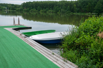 Wooden row boats are moored at the hotel pier for eco-friendly recreation and relaxation