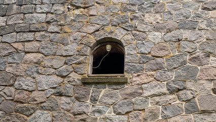 Security camera in the window of an abandoned castle in Latvia