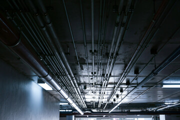 Sanitary system pipes and electrical cables installed under flat slab reinforced concrete structure...