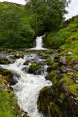 Allt nan Uamh Waterfall with stones and tree at Stronechrubie, Lairg, Highland, Scotland