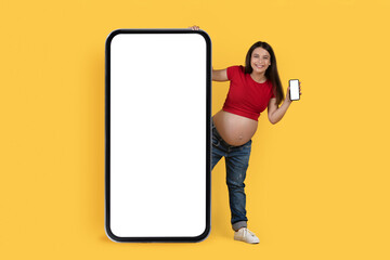 Pregnant Lady With Smartphone In Hand Peeking Out Behind Huge Blank Phone