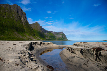 Fototapeta na wymiar Mighty mountains rising from the sea. The landscape of the stunning Norwegian island of Senja