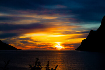 Fototapeta na wymiar A beautiful orange sunset over the Norwegian fjords