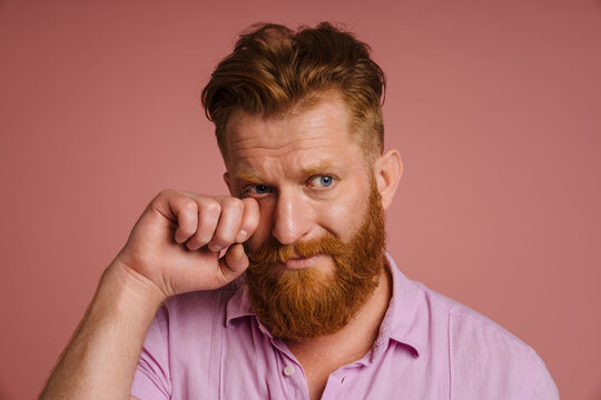 Ginger White Man With Beard Crying While Wiping His Tears