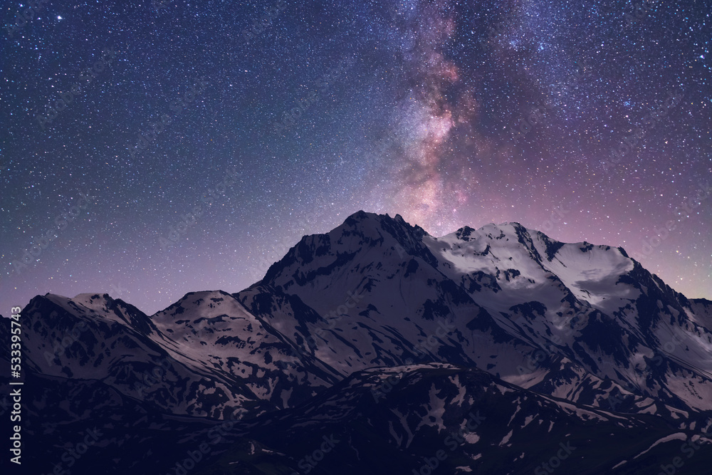 Wall mural night landscape. beautiful snow covered mountains in the starry night with milky way galaxy.