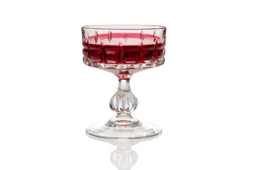 Vintage glass with Alchermes, Cassis red blackcurrant liqueur in antique glass isolated on white,...