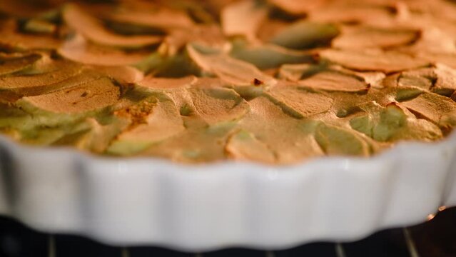 Cinnamon buns in the oven are cooked on a dish, timelapse. Process of making cinnamon rolls in home kitchen