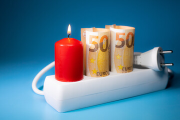 Energy price increase. Burning candles in an electrical extension cord. Increase in energy bill prices.