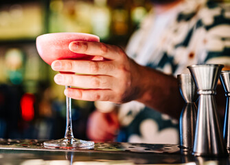 man hand bartender making sweet and sour refreshing cocktail on the bar counter