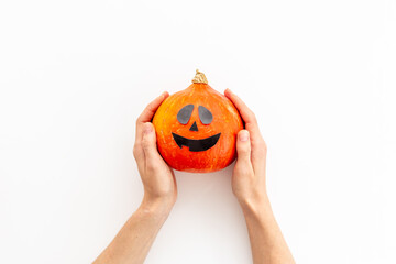 Halloween pumpkin head in hands. Festive Halloween background