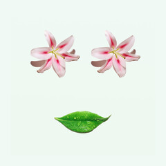 Fresh exotic flowers and green leaf, creative natural arrangement, beautiful female face idea. 